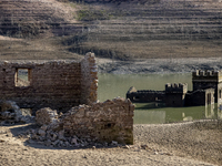 Hundreds of people are visiting the old town of Sant Roma de Sau, where normally the water of the Sau reservoir would almost completely cove...