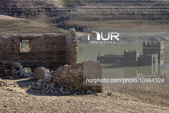 Hundreds of people are visiting the old town of Sant Roma de Sau, where normally the water of the Sau reservoir would almost completely cove...