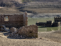 Hundreds of people are visiting the old town of Sant Roma de Sau, where normally the water of the Sau reservoir would almost completely cove...