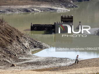 Hundreds of people are visiting the old town of Sant Roma de Sau, where normally the water of the Sau reservoir would almost completely cove...