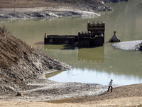 Hundreds of people are visiting the old town of Sant Roma de Sau, where normally the water of the Sau reservoir would almost completely cove...