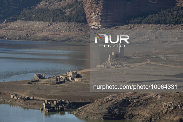 Hundreds of people are visiting the old town of Sant Roma de Sau, where normally the water of the Sau reservoir would almost completely cove...