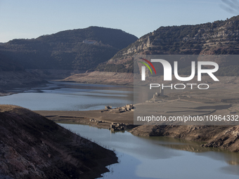 Hundreds of people are visiting the old town of Sant Roma de Sau, where normally the water of the Sau reservoir would almost completely cove...