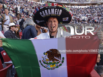 A person is wearing a sombrero and holding a Mexican flag inside the Plaza Mexico in Mexico City, as members of various animal rights, welfa...