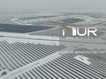 A new energy photovoltaic base is seen covered in snow in Suqian, Jiangsu Province, China, on February 5, 2024. (