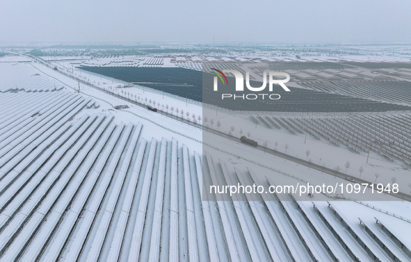 A new energy photovoltaic base is seen covered in snow in Suqian, Jiangsu Province, China, on February 5, 2024. 