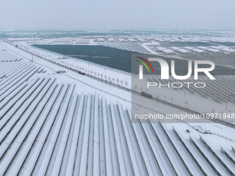 A new energy photovoltaic base is seen covered in snow in Suqian, Jiangsu Province, China, on February 5, 2024. (