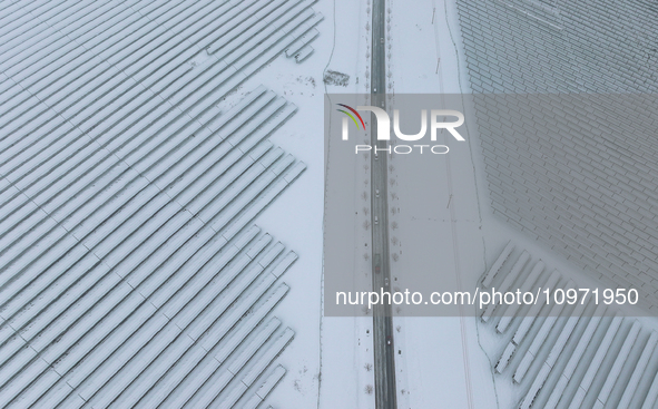 A new energy photovoltaic base is seen covered in snow in Suqian, Jiangsu Province, China, on February 5, 2024. 