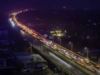 A large number of vehicles are traveling slowly on the section of the Huaian Bridge on the Changzhou-Shenzhen Expressway in Huai'an, China,...