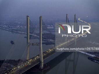 A large number of vehicles are traveling slowly on the section of the Huaian Bridge on the Changzhou-Shenzhen Expressway in Huai'an, China,...