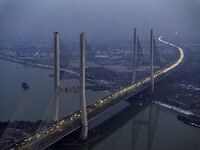 A large number of vehicles are traveling slowly on the section of the Huaian Bridge on the Changzhou-Shenzhen Expressway in Huai'an, China,...