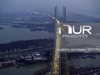 A large number of vehicles are traveling slowly on the section of the Huaian Bridge on the Changzhou-Shenzhen Expressway in Huai'an, China,...