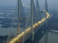 A large number of vehicles are traveling slowly on the section of the Huaian Bridge on the Changzhou-Shenzhen Expressway in Huai'an, China,...