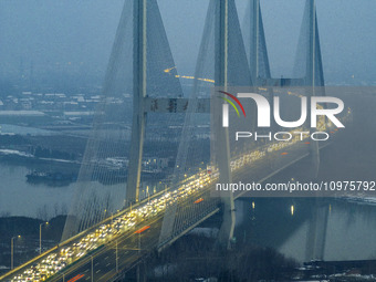 A large number of vehicles are traveling slowly on the section of the Huaian Bridge on the Changzhou-Shenzhen Expressway in Huai'an, China,...