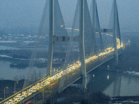 A large number of vehicles are traveling slowly on the section of the Huaian Bridge on the Changzhou-Shenzhen Expressway in Huai'an, China,...