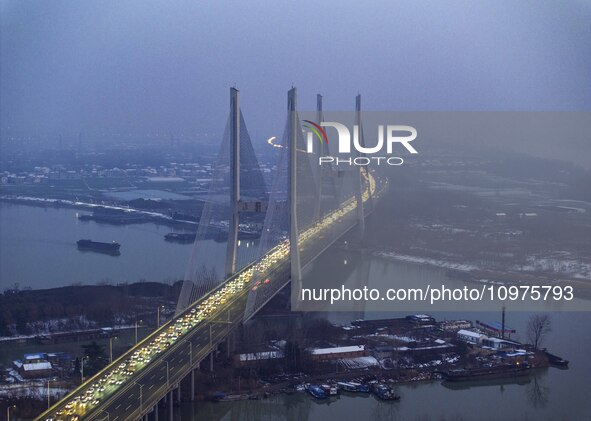 A large number of vehicles are traveling slowly on the section of the Huaian Bridge on the Changzhou-Shenzhen Expressway in Huai'an, China,...