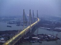 A large number of vehicles are traveling slowly on the section of the Huaian Bridge on the Changzhou-Shenzhen Expressway in Huai'an, China,...