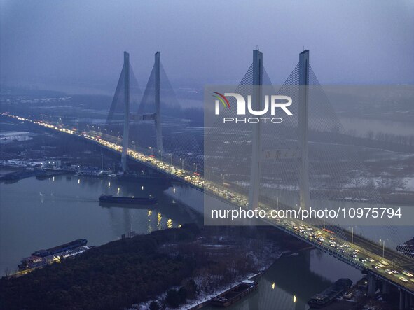 A large number of vehicles are traveling slowly on the section of the Huaian Bridge on the Changzhou-Shenzhen Expressway in Huai'an, China,...