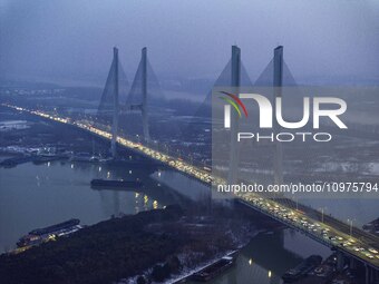 A large number of vehicles are traveling slowly on the section of the Huaian Bridge on the Changzhou-Shenzhen Expressway in Huai'an, China,...