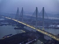 A large number of vehicles are traveling slowly on the section of the Huaian Bridge on the Changzhou-Shenzhen Expressway in Huai'an, China,...