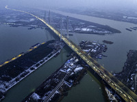 A large number of vehicles are traveling slowly on the section of the Huaian Bridge on the Changzhou-Shenzhen Expressway in Huai'an, China,...