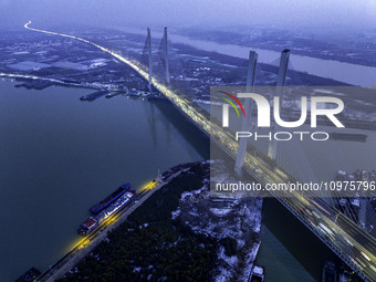 A large number of vehicles are traveling slowly on the section of the Huaian Bridge on the Changzhou-Shenzhen Expressway in Huai'an, China,...