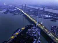 A large number of vehicles are traveling slowly on the section of the Huaian Bridge on the Changzhou-Shenzhen Expressway in Huai'an, China,...