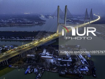 A large number of vehicles are traveling slowly on the section of the Huaian Bridge on the Changzhou-Shenzhen Expressway in Huai'an, China,...