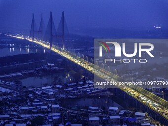 A large number of vehicles are traveling slowly on the section of the Huaian Bridge on the Changzhou-Shenzhen Expressway in Huai'an, China,...