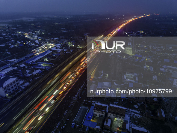 A large number of vehicles are traveling slowly on the section of the Huaian Bridge on the Changzhou-Shenzhen Expressway in Huai'an, China,...