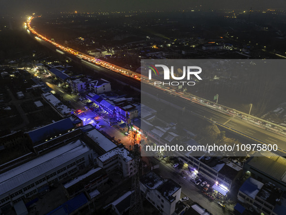 A large number of vehicles are traveling slowly on the section of the Huaian Bridge on the Changzhou-Shenzhen Expressway in Huai'an, China,...