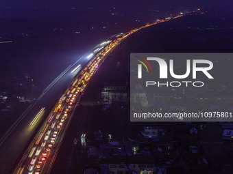 A large number of vehicles are traveling slowly on the section of the Huaian Bridge on the Changzhou-Shenzhen Expressway in Huai'an, China,...