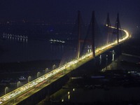 A large number of vehicles are traveling slowly on the section of the Huaian Bridge on the Changzhou-Shenzhen Expressway in Huai'an, China,...