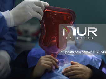 A child is receiving pediatric dental care as part of Dentist Day in Mexico at the Carlos A. Carrilo Elementary School in the Portales neigh...