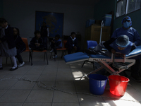 A child is receiving pediatric dental care as part of Dentist Day in Mexico at the Carlos A. Carrilo Elementary School in the Portales neigh...