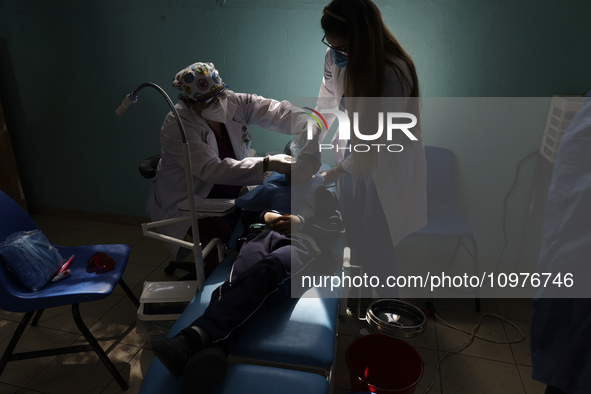 A child is receiving pediatric dental care as part of Dentist Day in Mexico at the Carlos A. Carrilo Elementary School in the Portales neigh...