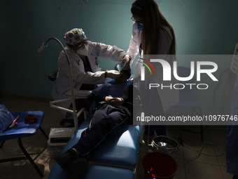 A child is receiving pediatric dental care as part of Dentist Day in Mexico at the Carlos A. Carrilo Elementary School in the Portales neigh...