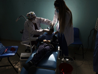 A child is receiving pediatric dental care as part of Dentist Day in Mexico at the Carlos A. Carrilo Elementary School in the Portales neigh...