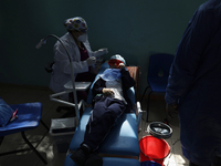 A child is receiving pediatric dental care as part of Dentist Day in Mexico at the Carlos A. Carrilo Elementary School in the Portales neigh...