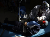 A child is receiving pediatric dental care as part of Dentist Day in Mexico at the Carlos A. Carrilo Elementary School in the Portales neigh...