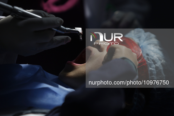 A child is receiving pediatric dental care as part of Dentist Day in Mexico at the Carlos A. Carrilo Elementary School in the Portales neigh...