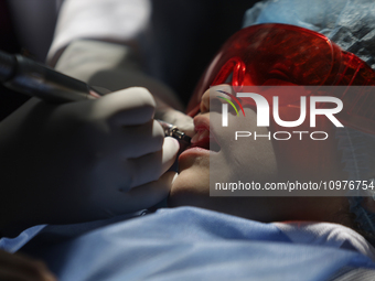 A child is receiving pediatric dental care as part of Dentist Day in Mexico at the Carlos A. Carrilo Elementary School in the Portales neigh...