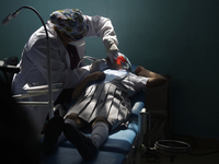 A child is receiving pediatric dental care as part of Dentist Day in Mexico at the Carlos A. Carrilo Elementary School in the Portales neigh...