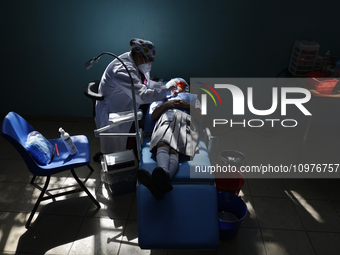 A child is receiving pediatric dental care as part of Dentist Day in Mexico at the Carlos A. Carrilo Elementary School in the Portales neigh...