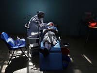 A child is receiving pediatric dental care as part of Dentist Day in Mexico at the Carlos A. Carrilo Elementary School in the Portales neigh...