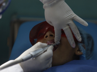 A child is receiving pediatric dental care as part of Dentist Day in Mexico at the Carlos A. Carrilo Elementary School in the Portales neigh...