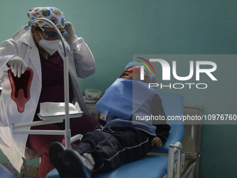 A child is receiving pediatric dental care as part of Dentist Day in Mexico at the Carlos A. Carrilo Elementary School in the Portales neigh...