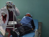 A child is receiving pediatric dental care as part of Dentist Day in Mexico at the Carlos A. Carrilo Elementary School in the Portales neigh...