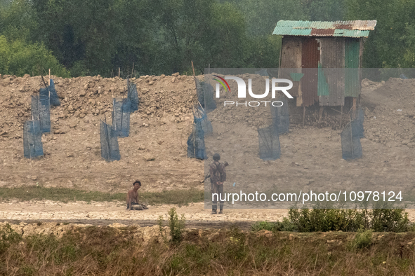 A member of Myanmar's Border Guard Police (BGP) is entering Bangladesh to escape armed conflict, arriving in Teknaf, Bangladesh, on February...