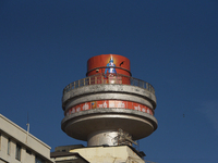 A bird is flying past 'The Ambassador,' an iconic hotel where 'Lord Ram' and 'Jai Shri Ram' are written on a poster in Mumbai, India, on Feb...